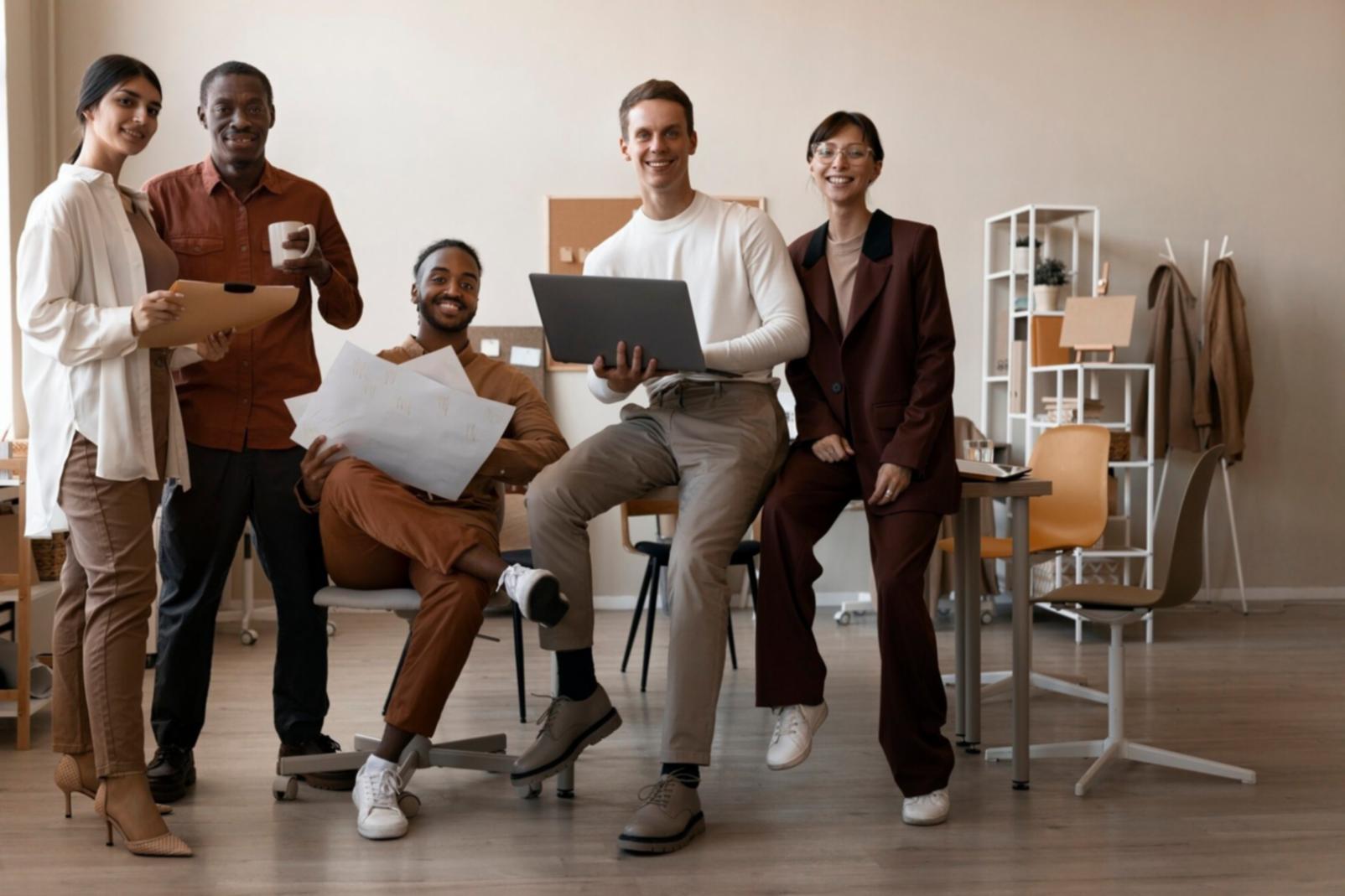 Person reviewing financial documents with calculator and laptop