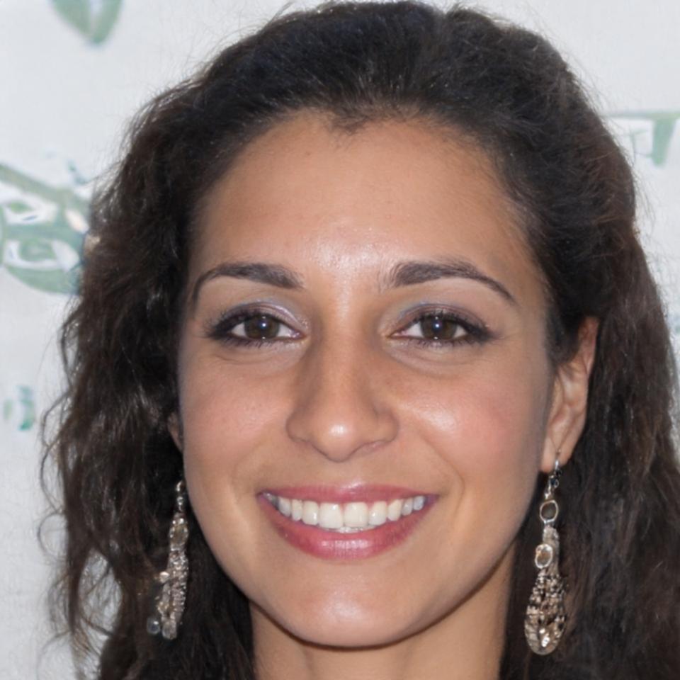 Sarah McKenzie, lead financial educator, smiling warmly in professional attire