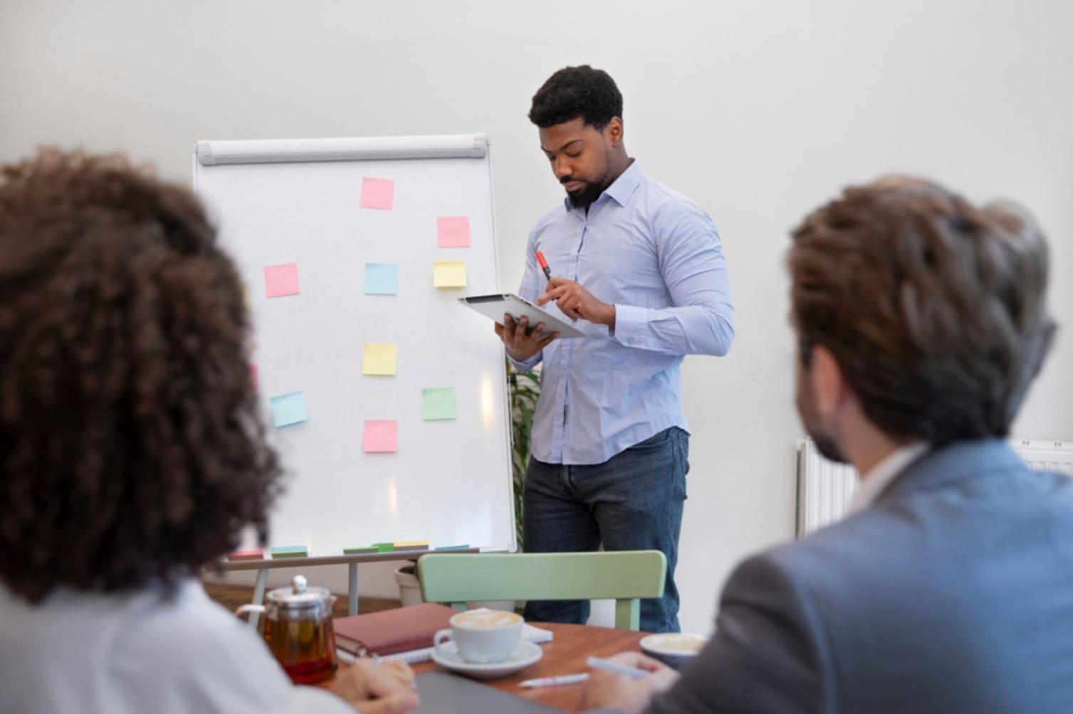 Simple budgeting tools including notebook, pen, and smartphone showing expense tracking